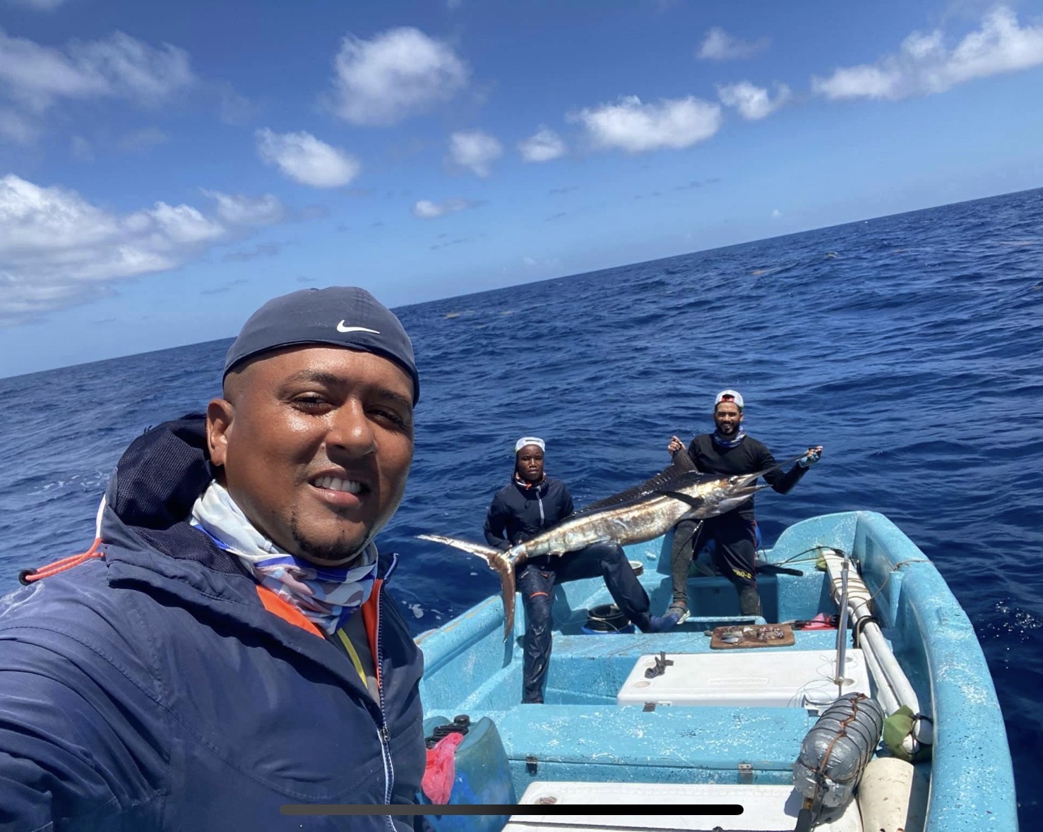 Captain and crew with a blue marlin offshore