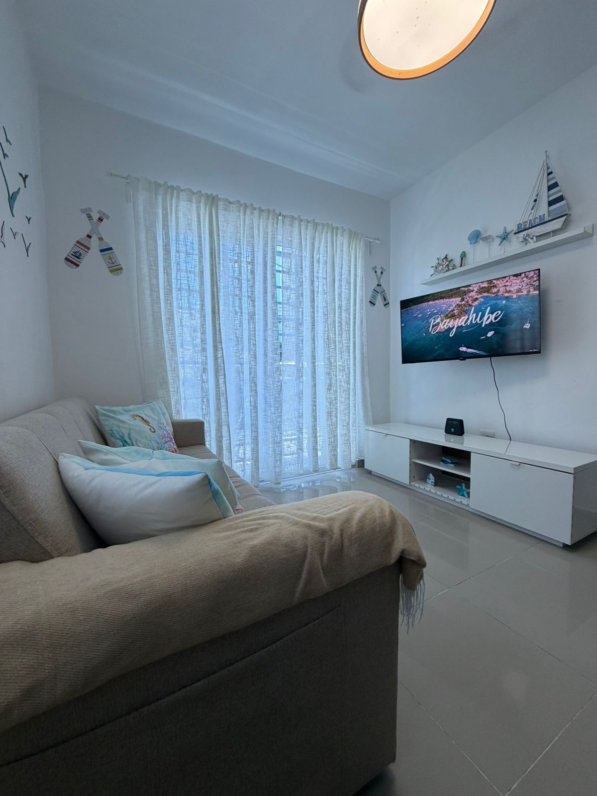 Bedroom detail with ocean-themed pillows